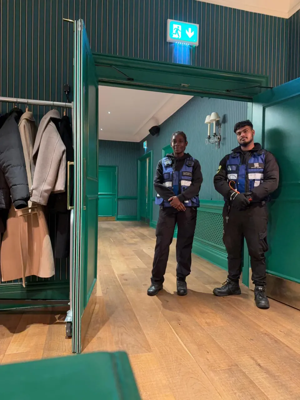 Two Zentinel officers on cloakroom and guest management duty at a black tie event